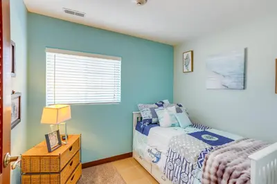 a bedroom with a bed and a blue wall at Waterfront Bass Island Retreat with Balcony and TV in Put-in-Bay