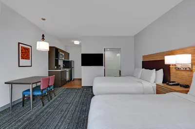a hotel room with two beds and a table at TownePlace Suites by Marriott Columbus Dublin in Dublin