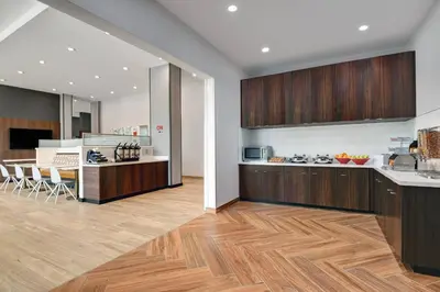a kitchen with wooden cabinets and a counter top at TownePlace Suites by Marriott Columbus Dublin in Dublin