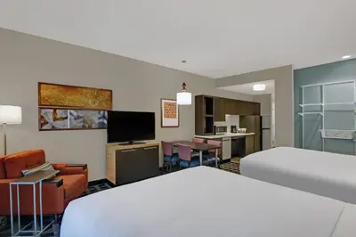 a hotel room with a bed and a living room at TownePlace Suites By Marriott Lima in Lima