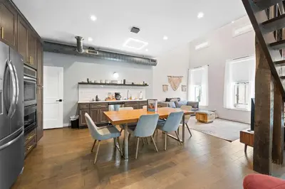 a kitchen and dining room with a table and chairs at 4 Apartments, Downtown, Walk to Cincy Stadiums! in Covington