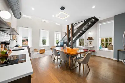 a kitchen and dining room with a table and chairs at 4 Apartments, Downtown, Walk to Cincy Stadiums! in Covington