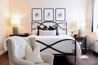 a bedroom with a large bed and a chair at Inn of Chagrin in Chagrin Falls