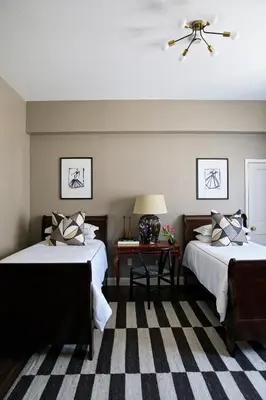 a bedroom with two beds and a table with a lamp at Inn of Chagrin in Chagrin Falls
