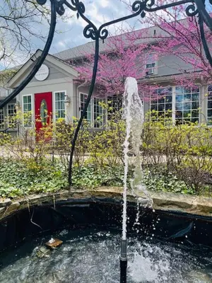 a water fountain in front of a house at Inn of Chagrin in Chagrin Falls