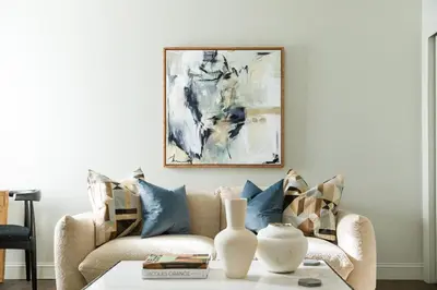 a living room with a couch and a painting on the wall at Inn of Chagrin in Chagrin Falls
