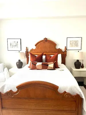 a bedroom with a large wooden bed with pillows at Inn of Chagrin in Chagrin Falls