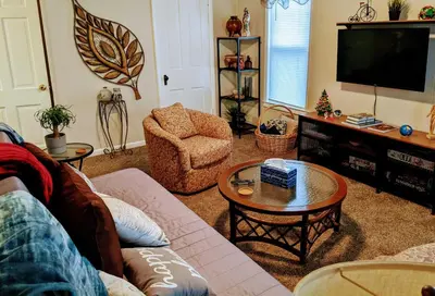 a living room with a couch and a tv at The Estate Loft in Downtown Milford in Milford