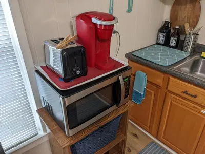 a kitchen with a coffee maker on top of a microwave at The Estate Loft in Downtown Milford in Milford
