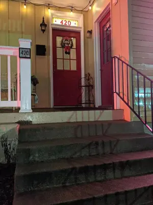 a house with a red door with a sign on it at The Estate Loft in Downtown Milford in Milford