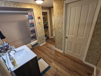 a bathroom with a sink and a mirror at The Estate Loft in Downtown Milford in Milford