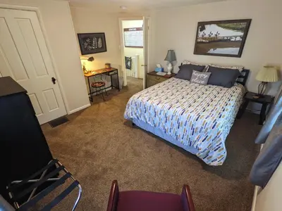 a bedroom with a bed and a desk and a chair at The Estate Loft in Downtown Milford in Milford