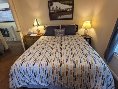 a bedroom with a large bed with a colorful bedspread at The Estate Loft in Downtown Milford in Milford
