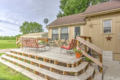 a large wooden deck with chairs and a table at Historic Ottawa Lake House Deck, Barn and 96 Acres! in Sylvania