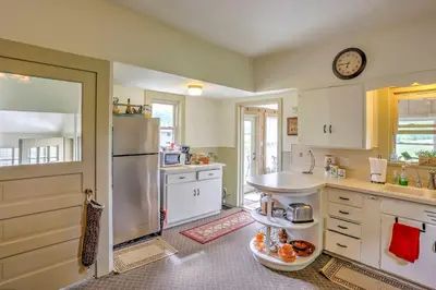 a kitchen with a sink and a refrigerator at Historic Ottawa Lake House Deck, Barn and 96 Acres! in Sylvania