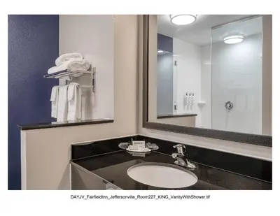 a bathroom with a sink and a large mirror at Fairfield Inn & Suites by Marriott Jeffersonville I-71 in Jeffersonville