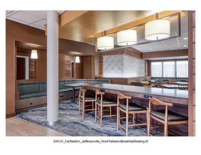 a dining room with a long table and chairs at Fairfield Inn & Suites by Marriott Jeffersonville I-71 in Jeffersonville