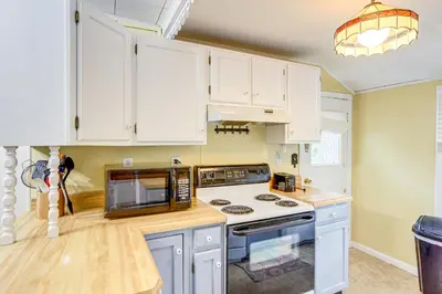 a kitchen with white cabinets and a microwave at Walk to Lake Historic Lakeside Marblehead Cottage in Lakeside