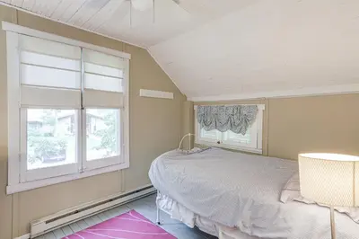 a bedroom with a bed and a window at Walk to Lake Historic Lakeside Marblehead Cottage in Lakeside