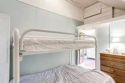 a bedroom with a bunk bed in a room at Walk to Lake Historic Lakeside Marblehead Cottage in Lakeside
