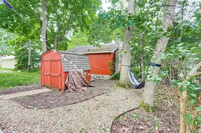 a red shed with a hammock in a yard at Walk to Lake Historic Lakeside Marblehead Cottage in Lakeside