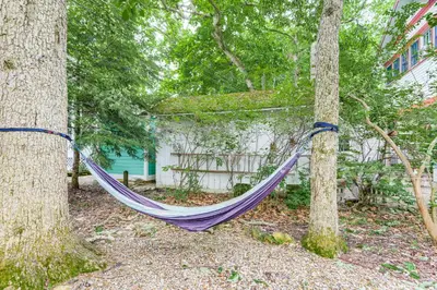 a purple hammock hanging between two trees in a yard at Walk to Lake Historic Lakeside Marblehead Cottage in Lakeside