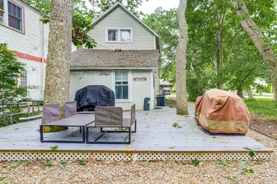 a patio with a table and chairs and a house at Walk to Lake Historic Lakeside Marblehead Cottage in Lakeside