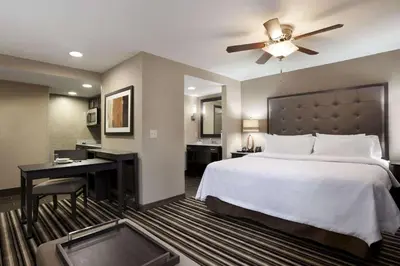 a hotel room with a bed and a desk and a ceiling fan at Homewood Suites by Hilton Columbus OSU, OH in Columbus