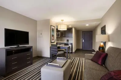 a living room with a couch and a flat screen tv at Homewood Suites by Hilton Columbus OSU, OH in Columbus