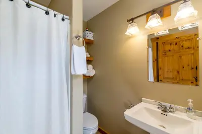 a bathroom with a sink and a toilet and a mirror at Scotch Pine . Trailside Lodging in Millersburg