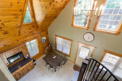 an overhead view of a living room with a table and a clock at Scotch Pine . Trailside Lodging in Millersburg