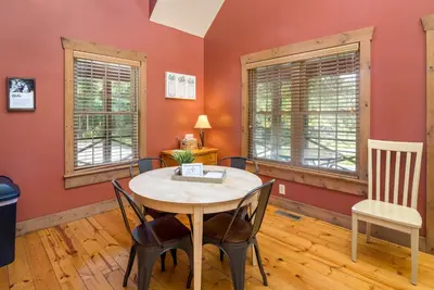 a dining room with a table and chairs at White Pine . Trailside Lodging in Millersburg
