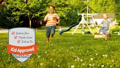 two children playing in a yard with a swing at White Pine . Trailside Lodging in Millersburg