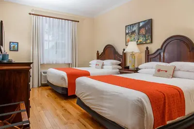 a hotel room with two beds and a window at Mills Park Hotel in Fairborn