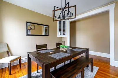 a dining room with a wooden table and chairs at Jungle House Luxury Stays - Columbus Downtown Short North in Columbus