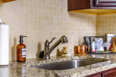 a kitchen counter with a sink and a bottle of soap at Jungle House Luxury Stays - Columbus Downtown Short North in Columbus