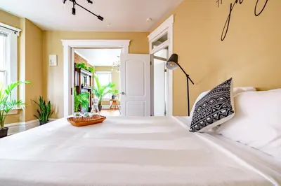 a bedroom with a large bed with white sheets at Jungle House Luxury Stays - Columbus Downtown Short North in Columbus