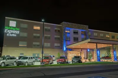 a hotel with cars parked in front of a parking lot at Holiday Inn Express & Suites Dayton North - Vandalia by IHG in Dayton