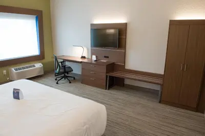 a hotel room with a bed and a desk with a television at Holiday Inn Express & Suites Dayton North - Vandalia by IHG in Dayton