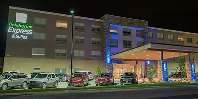 a parking lot with cars parked in front of a hotel at Holiday Inn Express & Suites Dayton North - Vandalia by IHG in Dayton