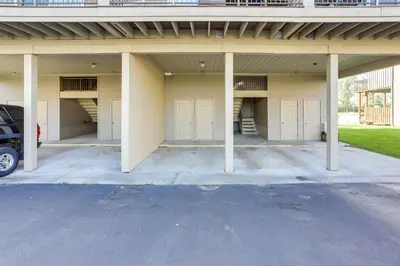 an empty garage with four white garage doors at Charming Condo on Lake Erie with Community Pool in Sand Beach