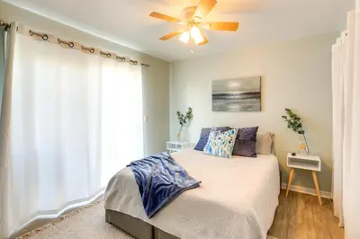 a bedroom with a bed and a ceiling fan at Charming Condo on Lake Erie with Community Pool in Sand Beach