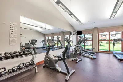 a gym with treadmills and elliptical machines at The Inn at Ohio Northern University in Ada