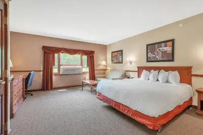 a hotel room with a bed and a desk at The Inn at Ohio Northern University in Ada