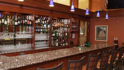 a bar in a restaurant with many bottles of alcohol at The Inn at Ohio Northern University in Ada