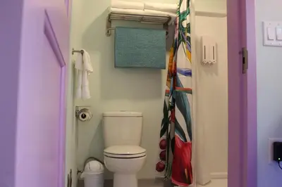 a small bathroom with a toilet and a shower at Worthington of Logan in Logan