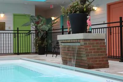 a swimming pool with a fountain in a building at Worthington of Logan in Logan