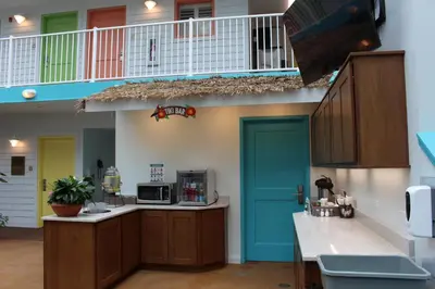 a large kitchen with a blue door and a balcony at Worthington of Logan in Logan
