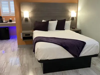 a bedroom with a large bed in a room at Worthington of Logan in Logan