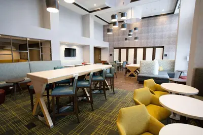 a dining room with tables and chairs and a table at Hampton Inn & Suites St Clairsville, Oh in Saint Clairsville